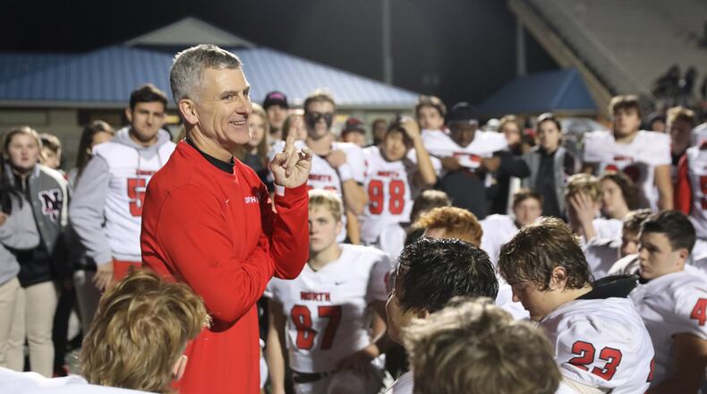 North Gwinnett coach Bill Stewart talks to his team after their win against McEachern in the Class 7A quarterfinals at McEachern High School Friday, November 29, 2019 in Powder Springs, Ga. North Gwinnett won 32-13. (JASON GETZ/SPECIAL TO THE AJC)