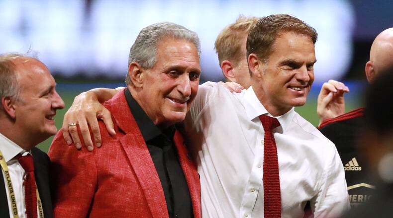 August 27, 2019 Atlanta: Atlanta United owner Arthur Blank and head coach Frank de Boer share a hug as they celebrate defeating Minnesota United 2-1 to win the U.S. Open Cup on Tuesday, August 27, 2019, in Atlanta.  Curtis Compton/ccompton@ajc.com