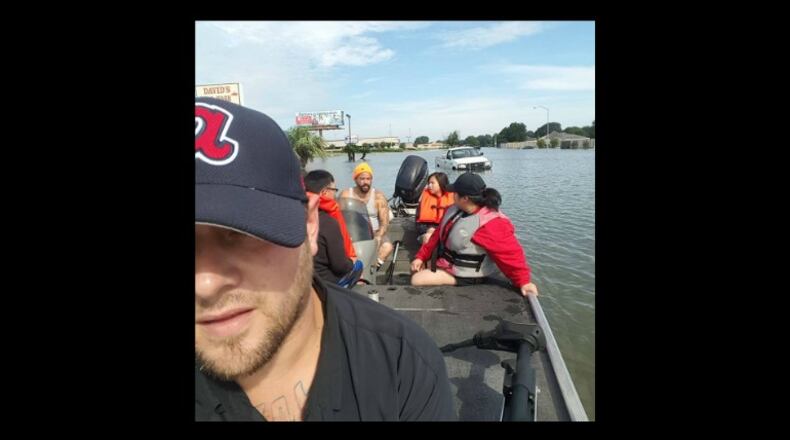 Joey Leonard uses a boat to bring people from their homes to stores for supplies. (Credit: Facebook)