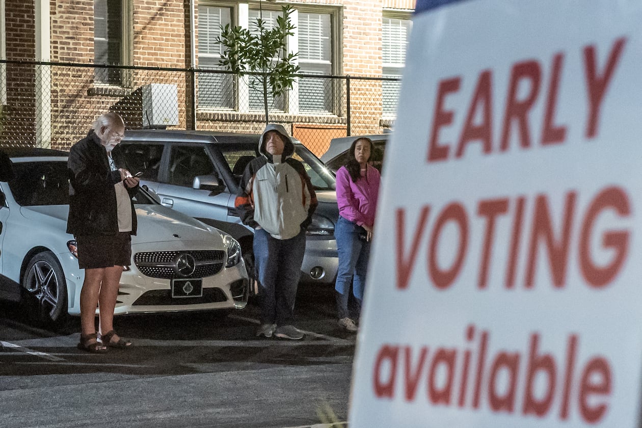 Voters line up before the polls open at the Joan P. Garner Library in Atlanta on the first day of the state's early voting period. As of Friday, 2.5 million Georgians had cast ballots during early voting, with a week left to go. (John Spink/AJC)