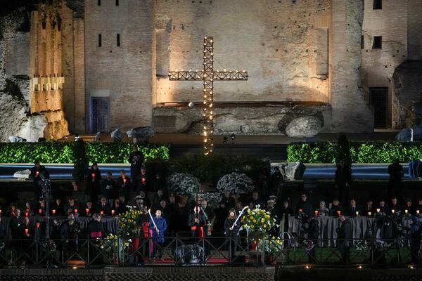 Cardinal Baldassare Reina, Vicar General of Pope Francis for the Diocese of Rome, leads the procession in front of the Colosseum during the Via Crucis (Latin for 'way of the cross') in Rome, Friday, April 18, 2025. (AP Photo/Andrew Medichini)