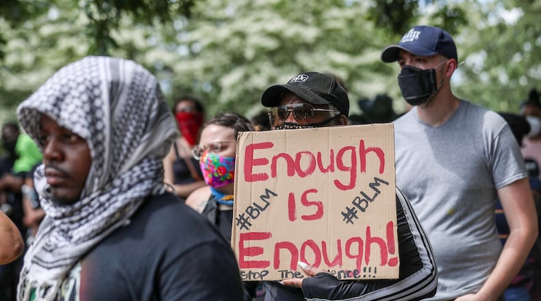 A Black Lives Matter supporter holds a sign during a rally at Atlanta’s Cleopas Park. Protests over the death of George Floyd in Minneapolis police custody continue around the United States, as his case renewed anger about incidents involving African Americans, police and race relations. Alyssa Pointer / alyssa.pointer@ajc.com