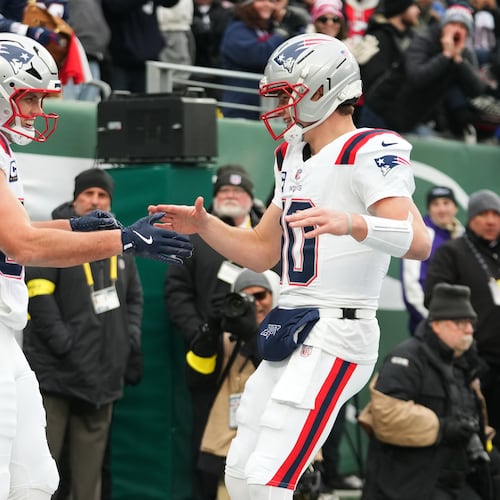 New England Patriots tight end Hunter Henry, left, celebrates after a touchdown against the New York Jets with teammate Drake Maye (10) during the first half of an NFL football game, Sunday, Dec. 28, 2025, in East Rutherford, N.J. (AP Photo/Frank Franklin)