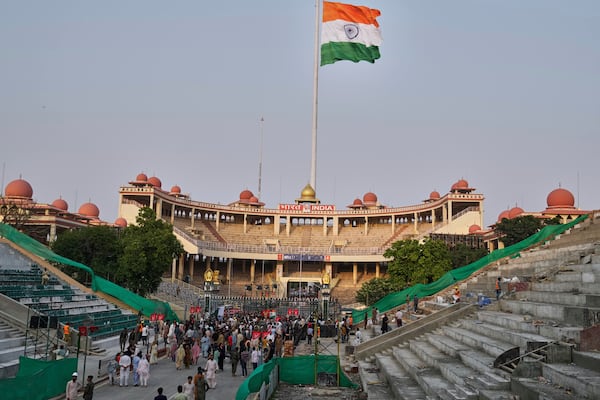 People gather near the closed gates for selfie after a daily closing ceremony by Pakistan's Rangers and Indian Border Security Forces soldiers, at the Wagah, a joint post on the Pakistan and India border, near Lahore, Pakistan, Saturday, May 3, 2025. (AP Photo/K.M. Chaudary)