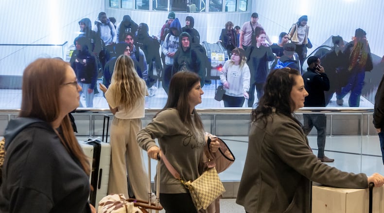 Passengers make their way through Hartfield-Jackson International Airport in Atlanta on Friday, Nov. 22, 2024. Nationally, AAA predicts a record 119.3 million people will leave home between Dec. 21 and New Year’s Day. (John Spink/AJC)