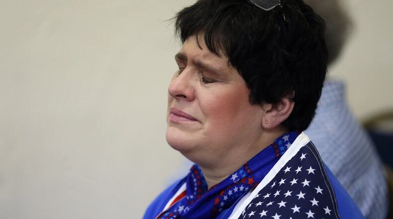 Theresa Sykes, who helped start a group called Team Trump Cobb Cobb County, during the benediction following the televised ceremony. Republicans watched the Inauguration of Donald Trump at a party at GOP headquarters in Marietta. BOB ANDRES /BANDRES@AJC.COM