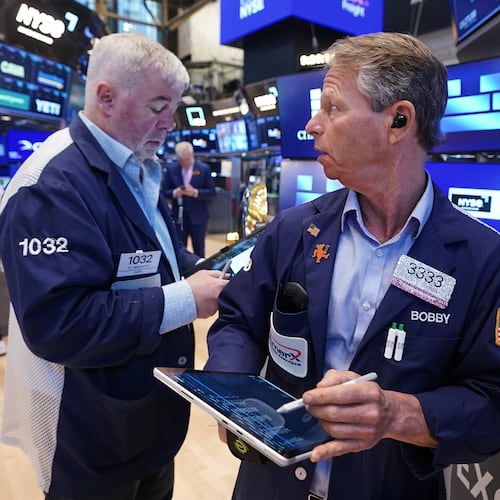 Traders Edward McCarthy, left, and Robert Charmak work on the floor of the New York Stock Exchange, Monday, June 1, 2026. (AP Photo/Richard Drew)
