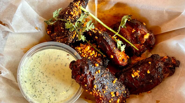 The wings at Little Rey get a lacquering of salsa macha, an infused oil mixture of deep-fried peanuts, garlic and toasted chiles de arbol. Angela Hansberger for The Atlanta Journal-Constitution