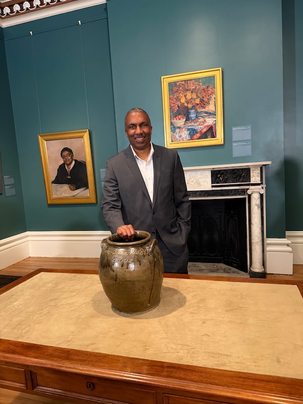 Yaba Baker, a fourth-generation grandson of David Drake, touches a Drake jar that was returned to his family by Telfair Museums. (Courtesy)