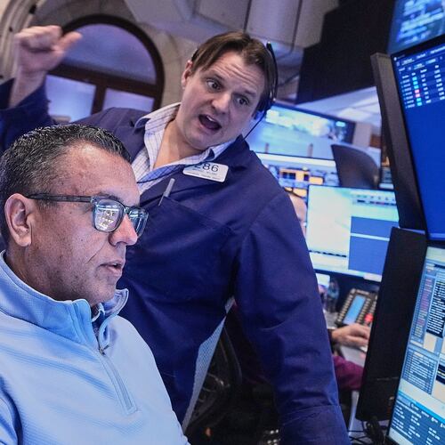Traders Robert Finnerty Jr., foreground, and Michael Milano work on the floor of the New York Stock Exchange, Monday, Jan. 26, 2026. (AP Photo/Richard Drew)