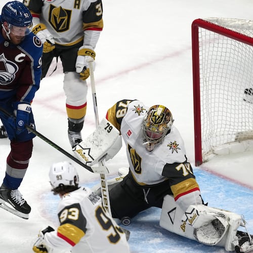 Vegas Golden Knights goaltender Carter Hart, right, stops a shot off the stick of Colorado Avalanche left wing Gabriel Landeskog during the third period in Game 1 of the Western Conference finals NHL hockey Stanley Cup playoff series Wednesday, May 20, 2026, in Denver. (AP Photo/David Zalubowski)