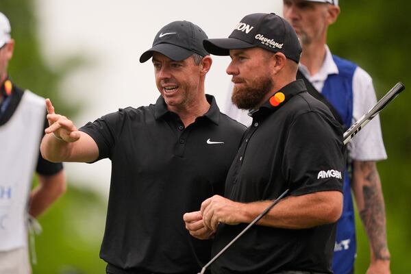 Rory McIlroy, of North Ireland, talks with teammate Shane Lowry, of Ireland, right, on the 12th green during the first round of the PGA Zurich Classic golf tournament at TPC Louisiana in Avondale, La., Thursday, April 24, 2025. (AP Photo/Gerald Herbert)