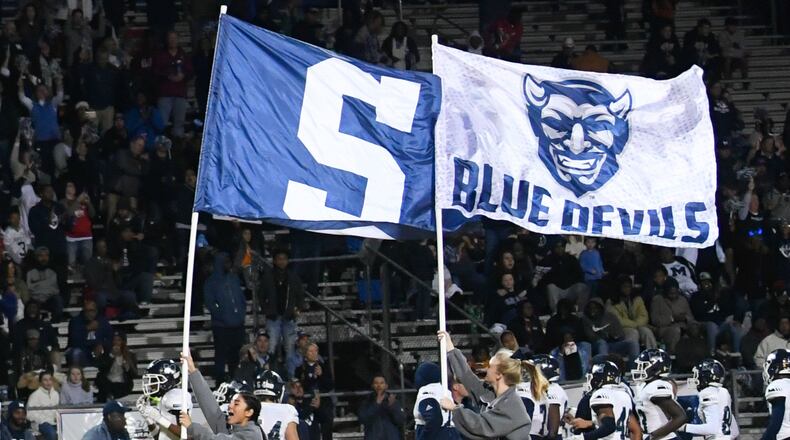 Marietta cheerleaders lead their team on to the field to take on Parkview during a high school semifinal playoff football game Friday, Dec. 6, 2019, in Lilburn. The Blue Devilos will play in the state champioship game Saturday. Photo by John Amis / Special