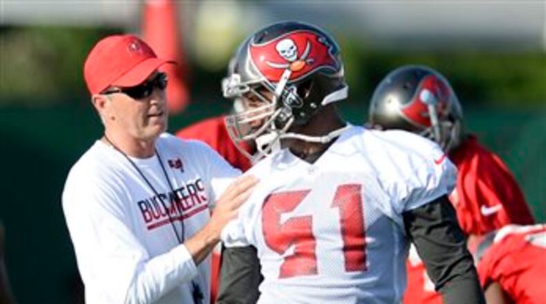 Tampa Bay Buccaneers head coach Dirk Koetter talks with linebacker Daryl Smith (51) during an NFL football camp Thursday July 28, 2016, in Tampa, Fla. (AP Photo/Jason Behnken)