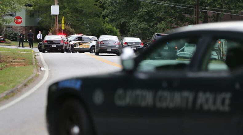 Multiple police vehicles were on the scene of an officer-involved shooting in Clayton County on Mon., May 16, 2016. BEN GRAY / BGRAY@AJC.COM