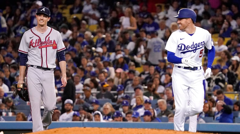 Los Angeles Dodgers' Freddie Freeman, right, smiles at Atlanta Braves starting pitcher Max Fried after being thrown out at first during the fourth inning of a baseball game Tuesday, April 19, 2022, in Los Angeles. (AP Photo/Mark J. Terrill)