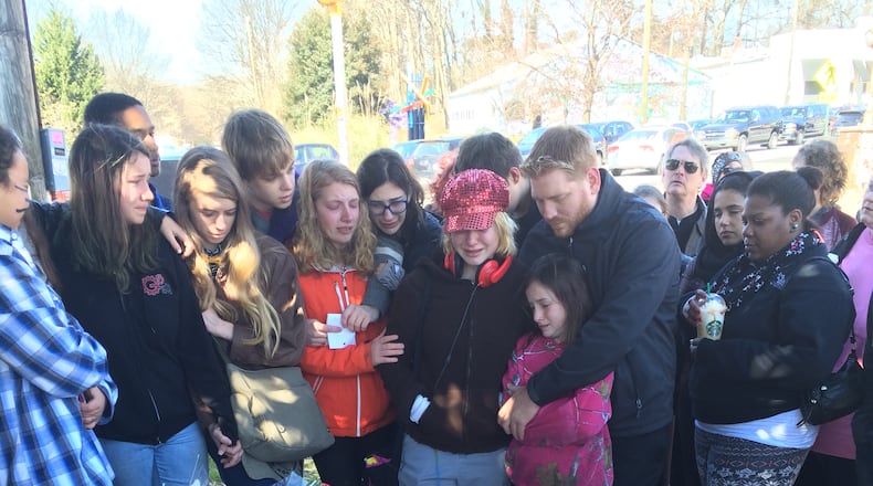 Alexia Hyneman’s friends and family gathered Saturday for a vigil near the site of the accident that killed the Grady High School student. CARRIE TEEGARDIN / CARRIE.TEEGARDIN@AJC.COM