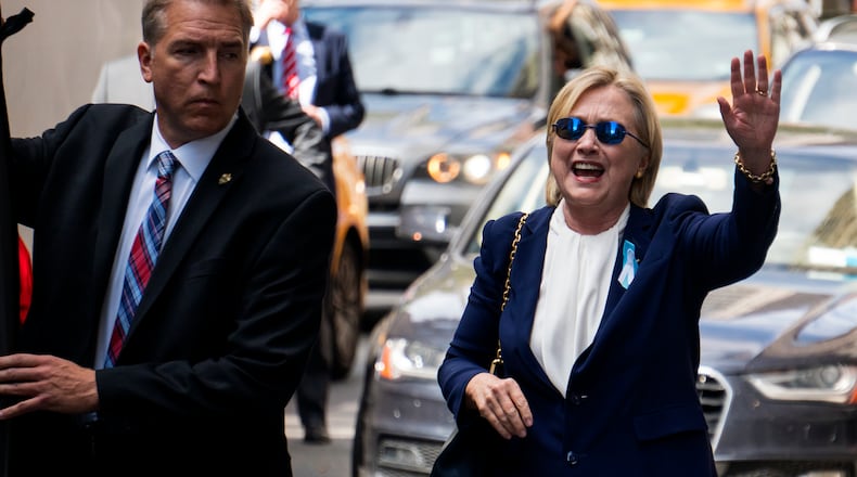 Democratic presidential candidate Hillary Clinton waves as she walks from her daughter's apartment building Sunday, Sept. 11, 2016, in New York. Clinton unexpectedly left Sunday's 9/11 anniversary ceremony in New York after feeling "overheated," according to her campaign. (AP Photo/Craig Ruttle)