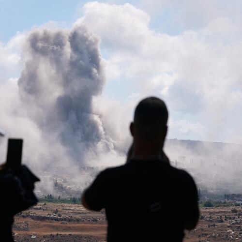 People from Mansouri record the smoke billowing from an Israeli-controlled detonation destroying their village, as seen from Hanniyeh village, southern Lebanon, Friday, Sept. 11, 2026. (AP Photo/Hussein Malla)
