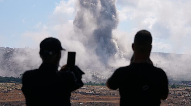 People from Mansouri record the smoke billowing from an Israeli-controlled detonation destroying their village, as seen from Hanniyeh village, southern Lebanon, Friday, Sept. 11, 2026. (AP Photo/Hussein Malla)