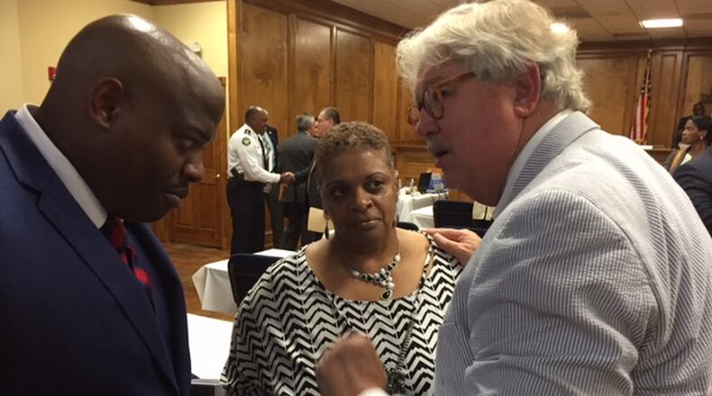 Freda Waiters (center) speaks with Ken Vance (right) on Wednesday June 8 at a meeting of the Georgia Peace Officer Standards and Training Council (POST). Vance is the director of POST. The council voted on Wednesday to revoke the police certification of Luther Lewis, a former Union City Police officer who shot and killed Waiters son, Ariston, in 2011. BRAD SCHRADE / BSCHRADE@AJC.COM