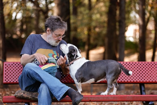 Penn Collins' dog, Josephine, accompanies him to Newtown Dream Dog Park in Johns Creek, where Collins crochets and Josephine plays. (Natrice Miller/AJC)