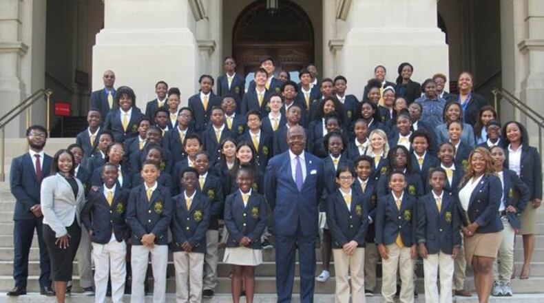 Donning their white polo shirts, khaki pants, and sharp navy blue blazers, students in the 21st year of the Fulton County District Attorney’s Office “Junior DA” program took their group photo with District Attorney Paul L. Howard, Jr. on the steps of the Georgia State Capitol, Thursday. CONTRIBUTED