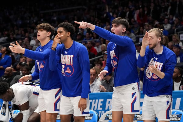 The American University bench reacts during the first half of a First Four college basketball game against Mount St. Mary's in the NCAA Tournament, Wednesday, March 19, 2025, in Dayton, Ohio. (AP Photo/Jeff Dean)
