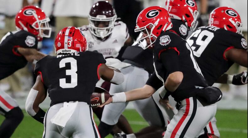 Georgia Bulldogs quarterback JT Daniels (18) hands off to Georgia Bulldogs running back Zamir White (3) on their first series during a NCAA football game between the Georgia Bulldogs and the Mississippi State Bulldogs on Saturday, Nov. 21, 2020 at Sanford Stadium in Athens. (Curtis Compton / Curtis.Compton@ajc.com)