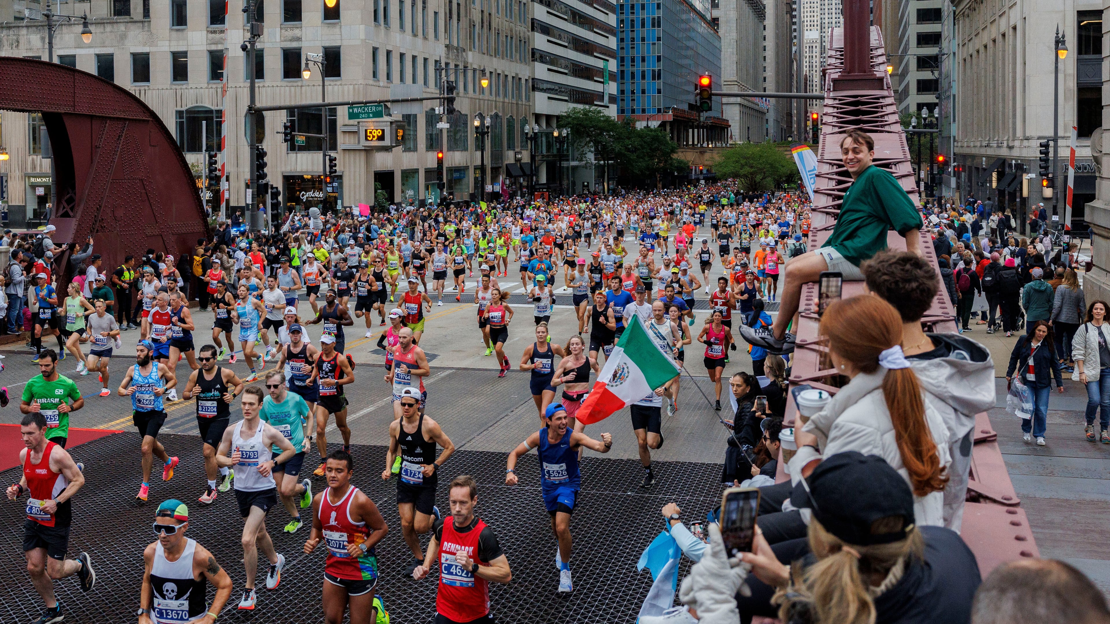 FILE - Runners cross the LaSalle Street bridge during the Chicago Marathon, Sunday, Oct. 13, 2024, in Chicago. (Armando L. Sanchez/Chicago Tribune via AP, File)