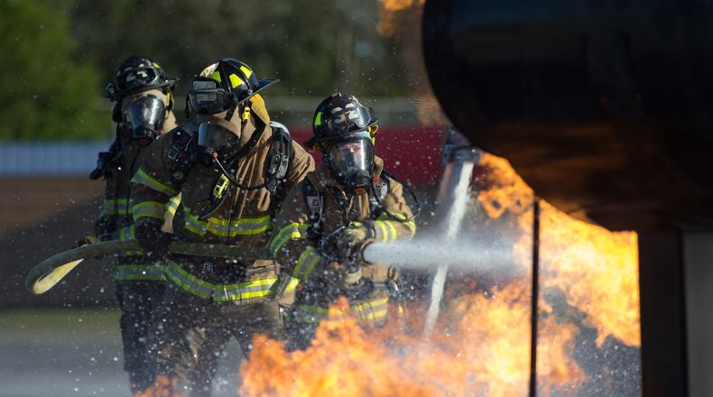 TRAINING FIRE--Atlanta firefighters work to extinguish a fire during a live burn training exercise at the Atlanta Fire Rescue Department training facility at Hartsfield-Jackson Atlanta International Airport, Thursday, April 7, 2016, in Atlanta. The exercise is part of an annual certification for airport rescue firefighters. BRANDEN CAMP/SPECIAL