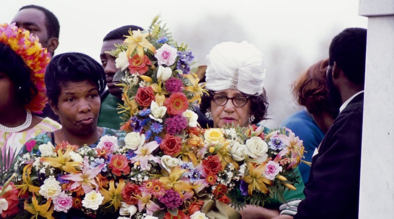 Women hold a funeral bouquet for the Rev. Martin Luther King Jr. at South View Cemetery in Atlanta on April 9, 1968. DECLAN HAUN / CONTRIBUTED BY CHICAGO HISTORY MUSEUM