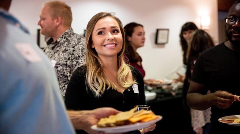 Emily Nelson, the host of dinner, chats with attendants over appetizers before the dinner begins at the Commons on Queen Anne on Aug. 2, 2018. (Rebekah Welch/Seattle Times/TNS)
