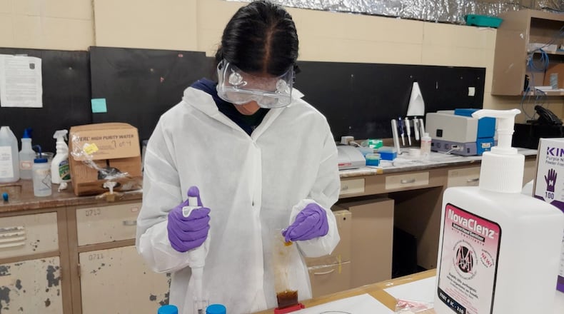 Pragathi Kasani-Akula, a 17-year-old Forsyth County student, works in a lab. Pragathi was honored recently by the White House for her work creating a low-cost, less-invasive test for breast cancer.  (Courtesy photo)