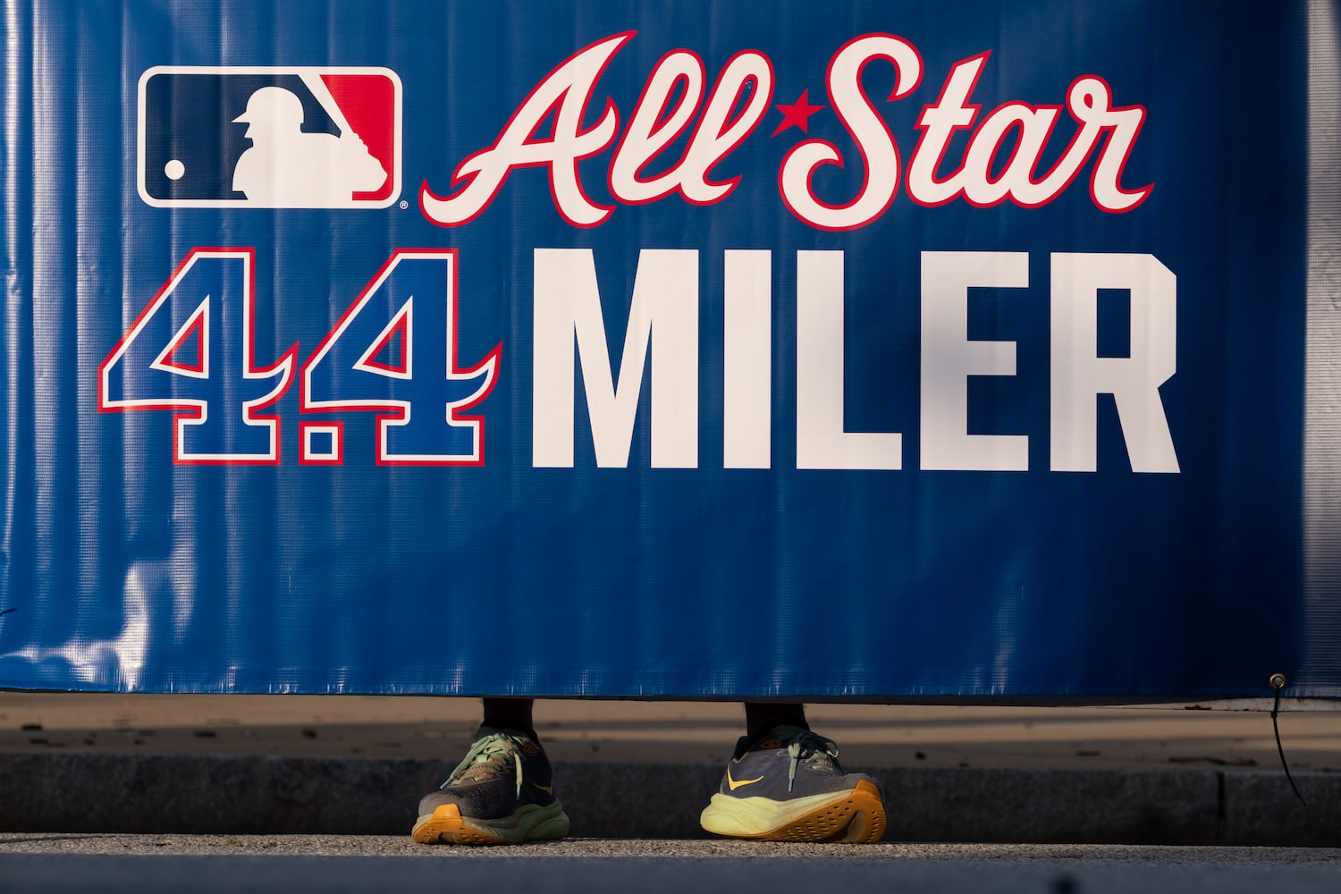 A fan watches from behind a barricade at the start of the MLB All-Star 4.4 Miler in Atlanta on Sunday, July 13, 2025.   Ben Gray for the Atlanta Journal-Constitution