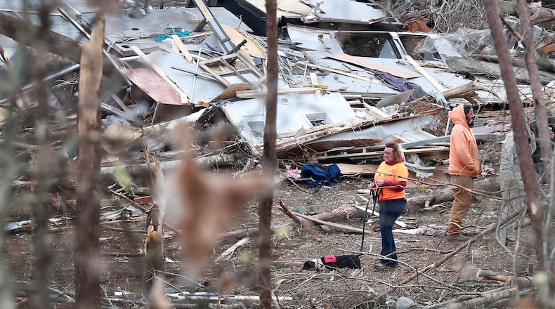 March 4, 2019 Beauregard, Ala: A woman and her dog make their way through the remains of shattered homes as rescue workers, local residents, and volunteers work through the debris along Lee Road 38 after a F-3 tornado on Monday, March 4, 2019, in Beauregard. Twenty-three people â including a six-year-old -- were killed by a storm Sunday, though that number is expected to climb, Lee County Sheriff Jay Jones told reporters Monday morning. The destruction area is at least a half a mile wide and at least a mile long, he added. Curtis Compton/ccompton@ajc.com