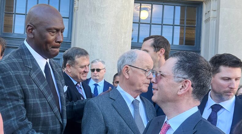 Michael Jordan, left, shakes hands with NASCAR attorney Lawrence Buterman as NASCAR chairman Jim France, center, looks away, Thursday, Dec. 11, 2025, outside the federal courthouse in Charlotte, N.C. (AP Photo/Jenna Fryer)