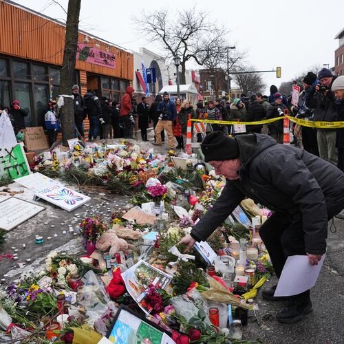 People visit a makeshift memorial for 37-year-old Alex Pretti, who was fatally shot by a U.S. Border Patrol officer over the weekend, Monday, Jan. 26, 2026, in Minneapolis. (AP Photo/Adam Gray)