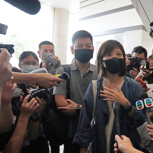 FILE - Chan Pui-man, associate publisher of Apple Daily newspaper walks out from a court in Hong Kong, June 19, 2021. (AP Photo/Kin Cheung), File)