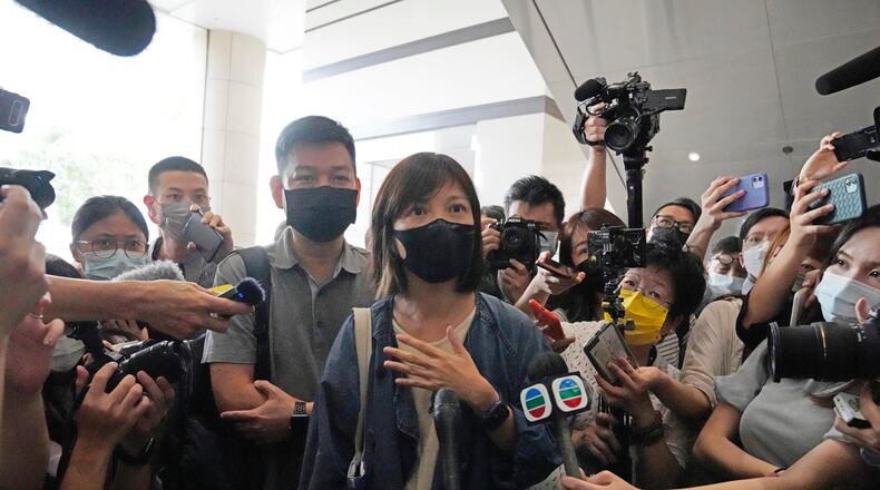 FILE - Chan Pui-man, associate publisher of Apple Daily newspaper walks out from a court in Hong Kong, June 19, 2021. (AP Photo/Kin Cheung), File)