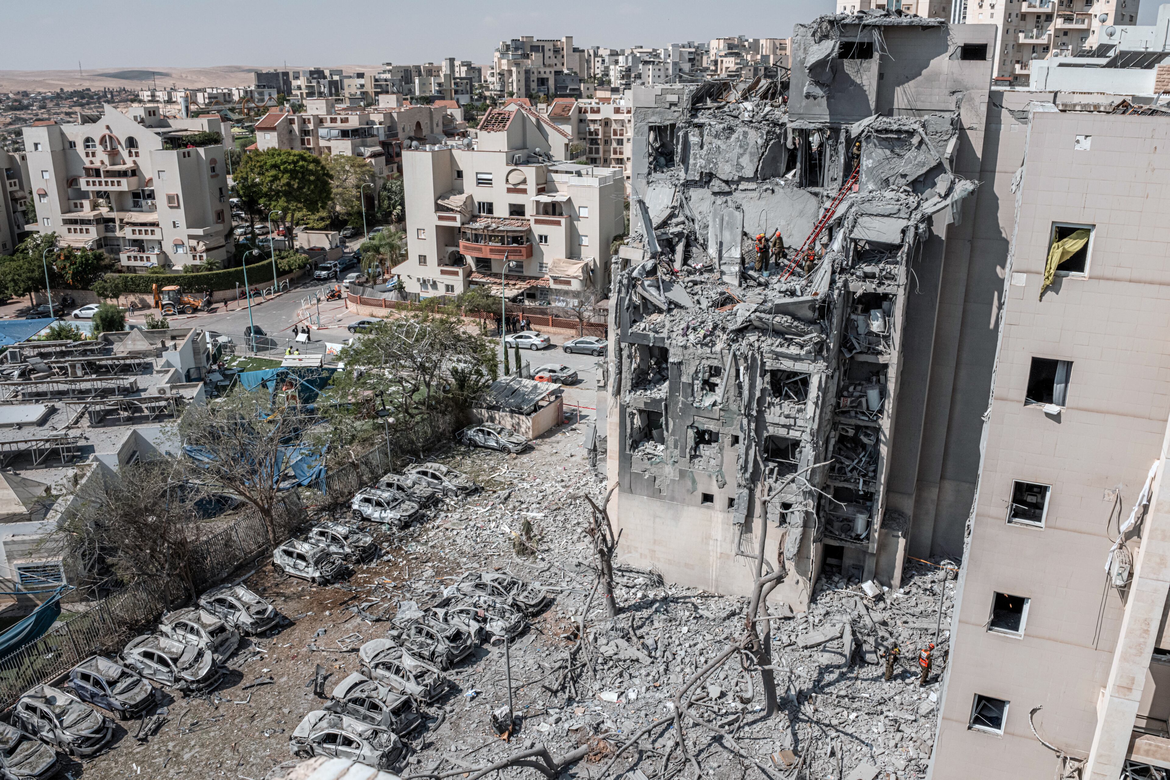 Emergency workers at the site of an Iranian missile attack on a residential building in Beersheba, Israel, on Tuesday, June 24, 2025. Iran launched a deadly strike in Beersheba, and Israel struck targets in Tehran early Tuesday, Israeli officials said, hours before the countries confirmed they had agreed to a cease-fire. (Daniel Berehulak/The New York Times)