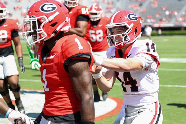 Georgia Red Team quarterback Gunner Stockton (14) celebrates with teammates after throwing a touchdown pass during the NCAA college football team's spring game, Saturday, April 12, 2025, in Athens, Ga. (AP Photo/Colin Hubbard)
