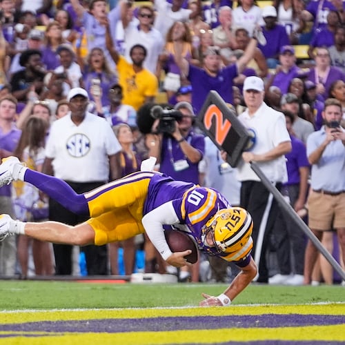LSU quarterback Sam Leavitt (10) dives into the end zone on a touchdown carry against Louisiana Tech in the first half of an NCAA college football game, Saturday, Sept. 12, 2026 in Baton Rouge, La. (AP Photo/Gerald Herbert)