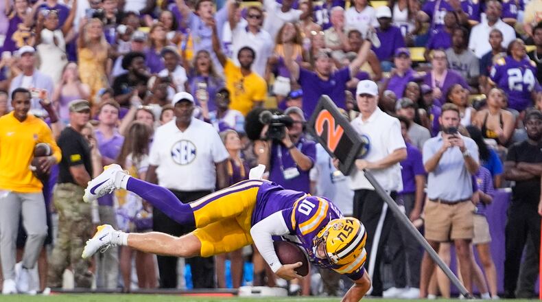 LSU quarterback Sam Leavitt (10) dives into the end zone on a touchdown carry against Louisiana Tech in the first half of an NCAA college football game, Saturday, Sept. 12, 2026 in Baton Rouge, La. (AP Photo/Gerald Herbert)