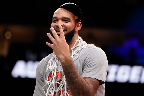 Auburn forward Johni Broome wears the net after the Elite Eight of the NCAA college basketball tournament Michigan State, Sunday, March 30, 2025, in Atlanta. (AP Photo/Brynn Anderson)