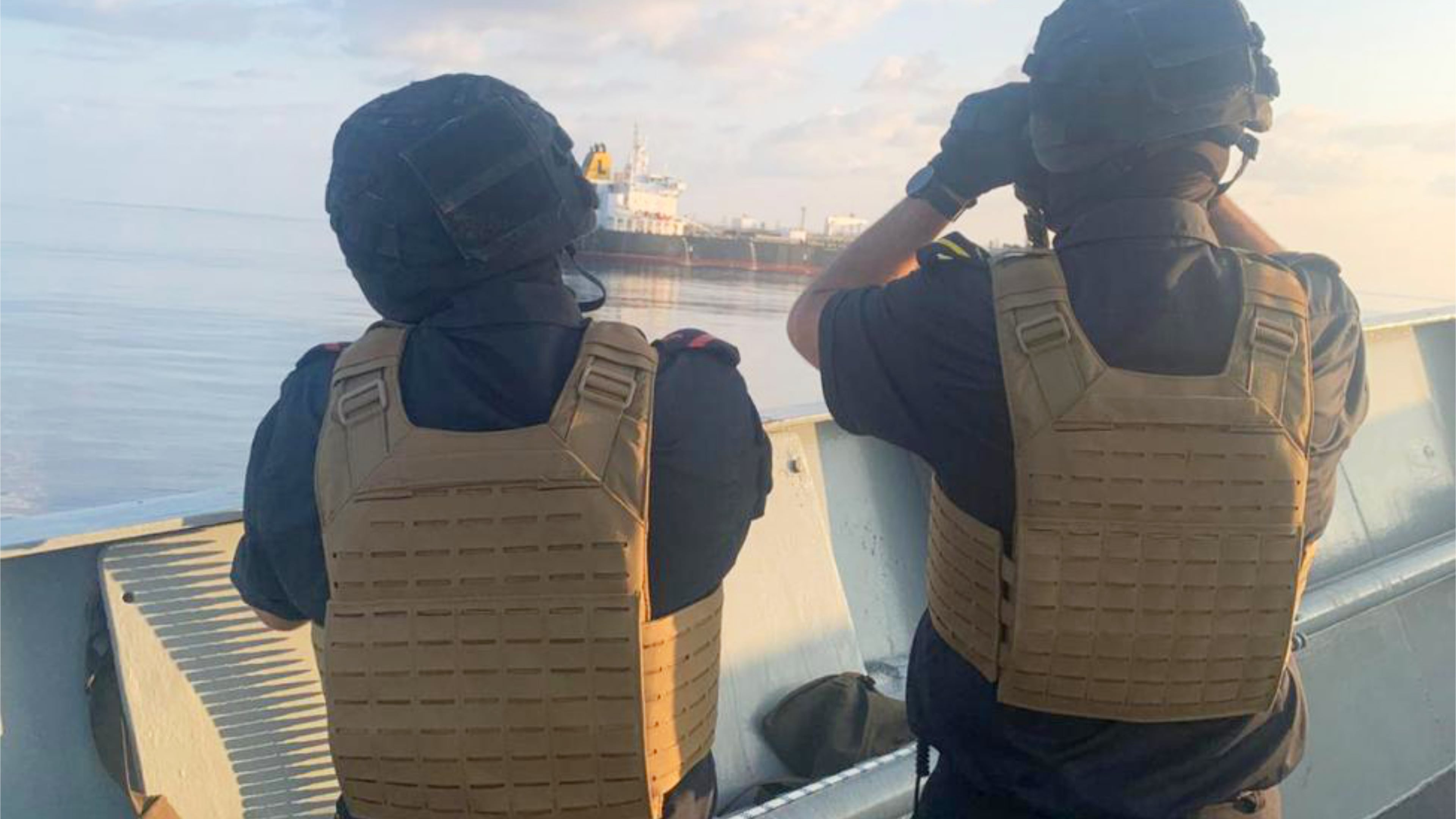 Two members of the European Union's Operation Atalanta aboard the ESPS Victoria watch the Hellas Aphrodite off the coast of Somalia in the Arabian Sea on Friday, Nov. 7, 2025. (European Union's Operation Atalanta via AP)