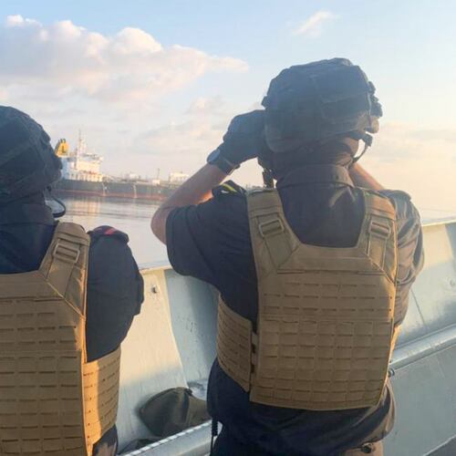 Two members of the European Union's Operation Atalanta aboard the ESPS Victoria watch the Hellas Aphrodite off the coast of Somalia in the Arabian Sea on Friday, Nov. 7, 2025. (European Union's Operation Atalanta via AP)