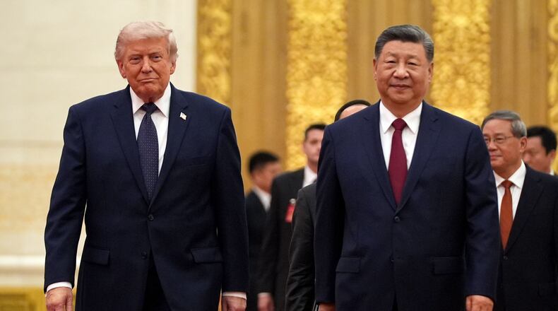 FILE - President Donald Trump, left, and Chinese President Xi Jinping arrive during a state dinner at the Great Hall of the People, May 14, 2026, in Beijing. (AP Photo/Mark Schiefelbein, File)