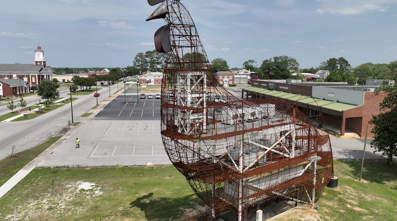The steel framework of a giant chicken looms over the town of Fitzgerald, Wednesday, May 24, 2023. Fitzgerald - population 9,053 - set out to construct a chicken that would be the largest topiary in the world. The former mayor Jim Puckett set out to build this thing, hoping that it would attract visitors. He even had an idea that it could double as an Airbnb. But voters didn't like the idea. They voted him out in Nov. 2021 over it. But the structure still stands. (Hyosub Shin / Hyosub.Shin@ajc.com)