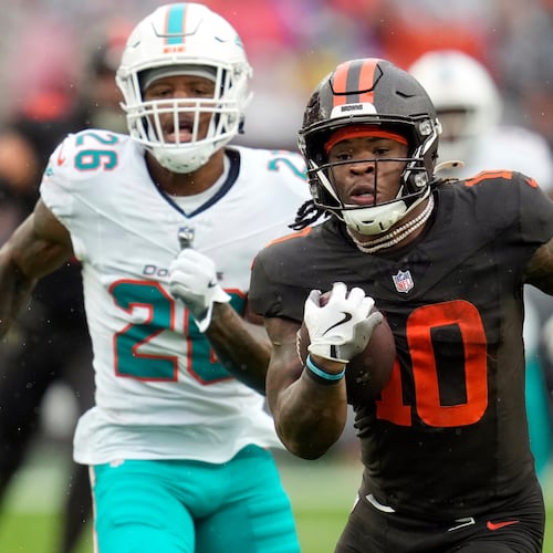 Cleveland Browns running back Quinshon Judkins (10) carries the ball ahead of Miami Dolphins cornerback Rasul Douglas (26) in the first half of an NFL football game in Cleveland, Sunday, Oct. 19, 2025. (AP Photo/Sue Ogrocki)